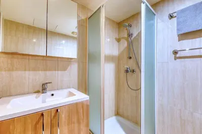 a bathroom with a sink and a shower at Kama Lifestyle Modern apt with sea view in Protaras