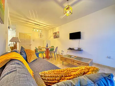 a living room with a couch and a table at Sea and Lake Breeze 1BR Apt in Larnaka