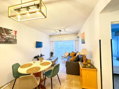 a living room with a table and a couch at Sea and Lake Breeze 1BR Apt in Larnaka