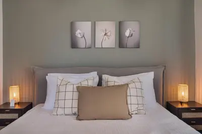a bedroom with three pictures on the wall above a bed at Phaedrus Living Larnaca Tsimintia Retreat in Larnaka