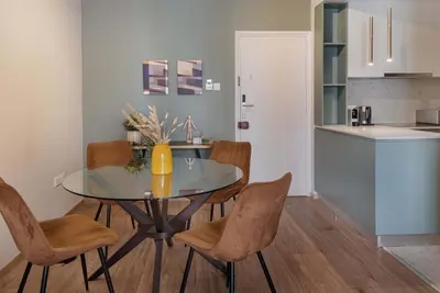 a kitchen and dining room with a glass table and chairs at Phaedrus Living Larnaca Tsimintia Retreat in Larnaka