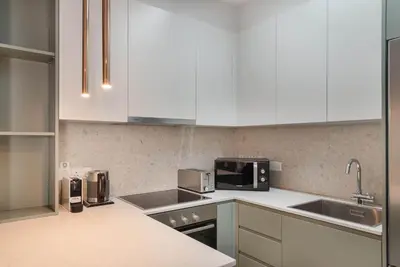 a kitchen with white cabinets and a sink at Phaedrus Living Larnaca Tsimintia Retreat in Larnaka