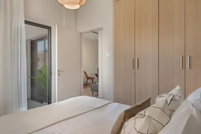 a bedroom with a white bed and a mirror at Phaedrus Living Larnaca Tsimintia Retreat in Larnaka