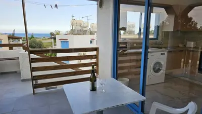 a bottle of wine on a table in a kitchen at STAY Chrisoula Beach Garden in Voroklini