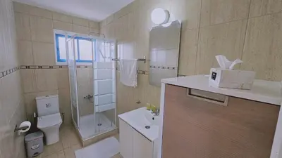 a bathroom with a toilet and a shower and a sink at STAY Chrisoula Beach Garden in Voroklini