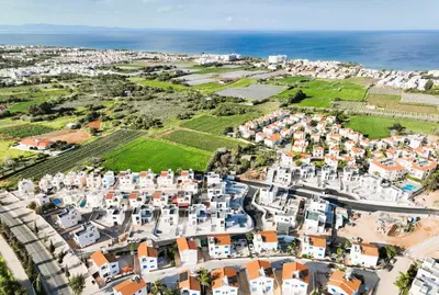 an aerial view of a town with white buildings and the ocean at Villa Vitalia - 3 En-suite Beds with Private Pool in Paralimni