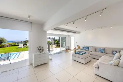 a living room with a couch and a table at Protaras Sirina Seafront Paradise in Protaras