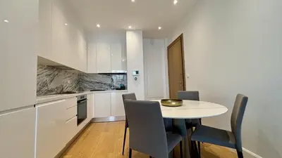 a kitchen and dining room with a table and chairs at Oxford House Apt by TrulyCyprus in Limassol