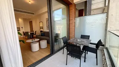 a dining room with a table and chairs in a room at Oxford House Apt by TrulyCyprus in Limassol