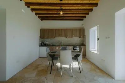 a kitchen with a table and chairs in a room at Dipaton House in Vasa 1 in Limassol