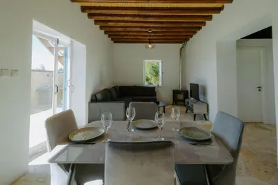 a dining room with a table with wine glasses on it at Dipaton House in Vasa 1 in Limassol