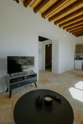 a living room with a table and a tv at Dipaton House in Vasa 1 in Limassol