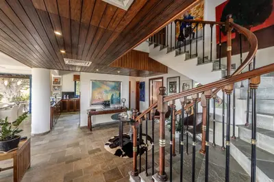 a staircase in a home with a wooden ceiling at Ayia Napa Sycamore SeaView in Ayia Napa