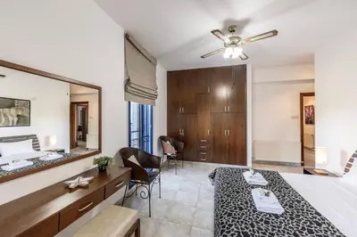 a bedroom with a bed and a large mirror at Ayia Napa Sycamore SeaView in Ayia Napa