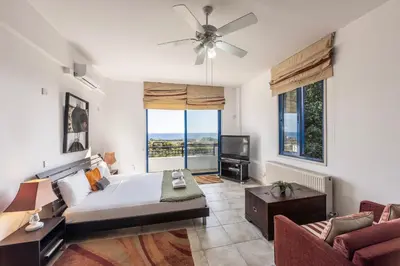 a living room with a bed and a couch at Ayia Napa Sycamore SeaView in Ayia Napa