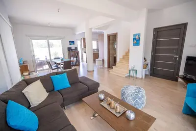 a living room with a couch and a table at Hubstay - Blue Harmony Villa in Protaras - 5 min Walk to the Beach in Paralimni