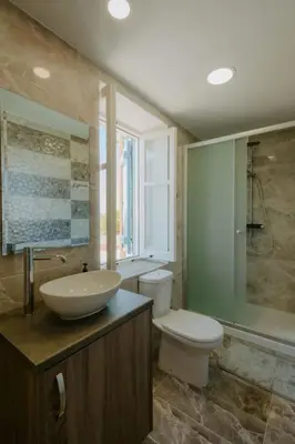 a bathroom with a sink and a toilet and a shower at Dipaton House in Vasa 2 in Vasa Kilaniou