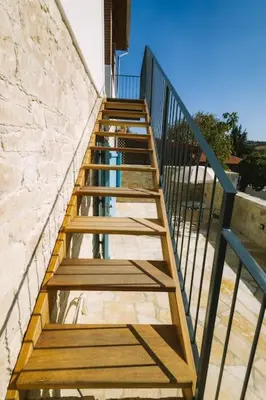 a set of wooden stairs leading up to a building at Dipaton House in Vasa 2 in Vasa Kilaniou
