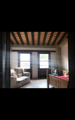 a living room with a couch and a bed at Clover Cottage in Limassol