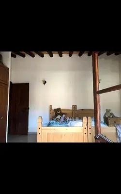 a bedroom with a wooden bed in a room at Clover Cottage in Limassol