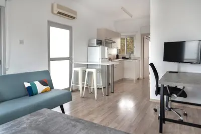 a living room with a couch and a table at Phaedrus Living Larnaca Harbour Heights in Larnaka