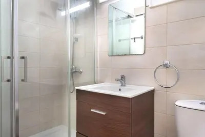 a bathroom with a sink and a shower at Phaedrus Living Larnaca Harbour Heights in Larnaka