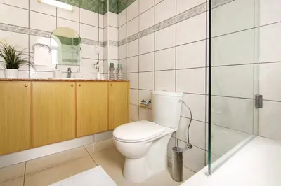 a bathroom with a toilet and a sink and a shower at Villa Alyson in Paralimni