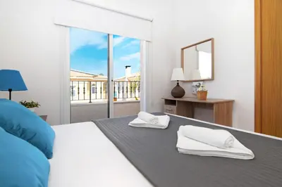 a bedroom with a white bed with towels on it at Villa Alyson in Paralimni