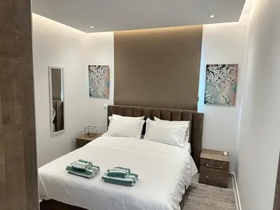 a bedroom with a bed with two towels on it at Joanna & Arya Central Engomi Apts in Nicosia