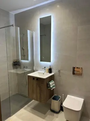 a bathroom with a sink and a toilet and a mirror at Joanna & Arya Central Engomi Apts in Nicosia