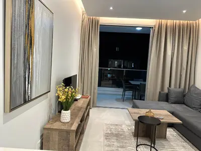 a living room with a couch and a table at Joanna & Arya Central Engomi Apts in Nicosia