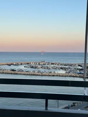 a view of the beach with a ship in the water at Sea View 1BR With Pool Access in Larnaka