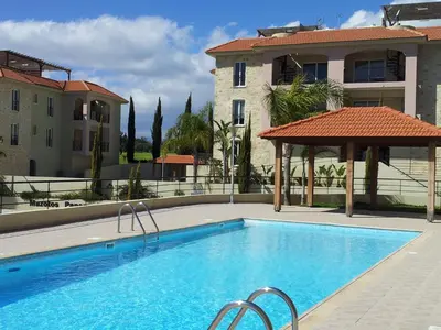 a swimming pool in front of a building at Mazotos Panoramic Village in Mazotos
