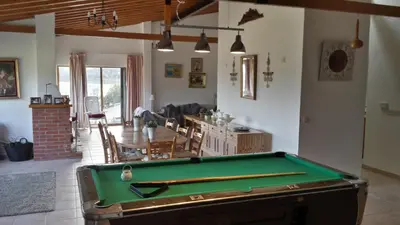 a room with a pool table and a living room at Villa in Moniatis in Moniatis