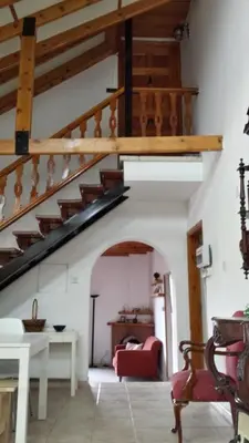 a living room with a staircase in a house at Villa in Moniatis in Moniatis