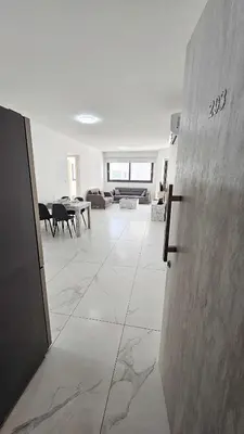 a large white room with a living room and a table at Modern Wellness Escape Apartment with Optional Health Transformation Retreat in Larnaka
