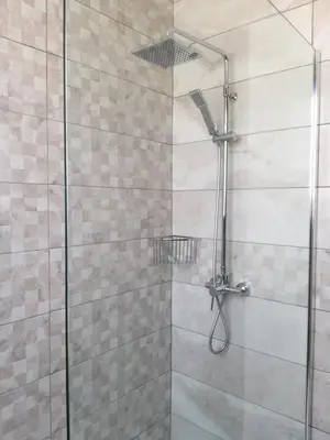 a shower stall with a glass shower door at Marios Villa in Larnaka