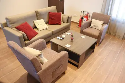 a living room with a couch and two chairs and a table at Marios Villa in Larnaka