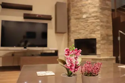 two vases with flowers on a table in a living room at Marios Villa in Larnaka