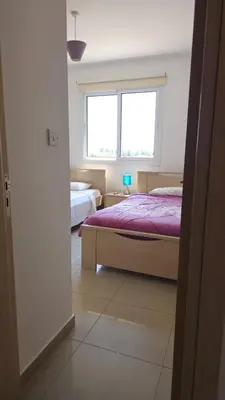 a bedroom with two beds and a window at Obv 5201 in Pyla