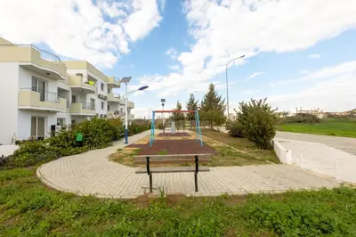 an empty playground in front of a building at Obv 5201 in Pyla