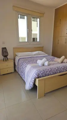 a bedroom with a bed with two towels on it at Obv 5201 in Pyla