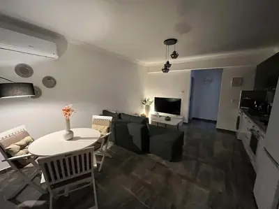 a living room with a white table and a couch at The Aqua Marine Flat in Iskele