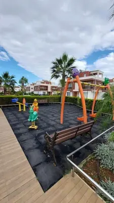 a child is playing on a playground with a slide at The Aqua Marine Flat in Iskele