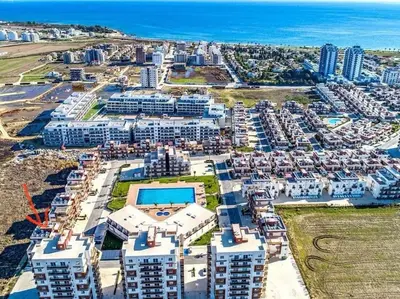 an aerial view of a large apartment complex near the ocean at The Aqua Marine Flat in Iskele