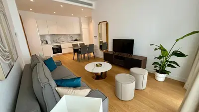 a living room with a couch and a table at Bali Residence Apt by TrulyCyprus in Limassol