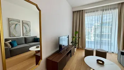a living room with a couch and a large mirror at Bali Residence Apt by TrulyCyprus in Limassol