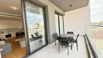a dining room and kitchen with a table and chairs at Bali Residence Apt by TrulyCyprus in Limassol