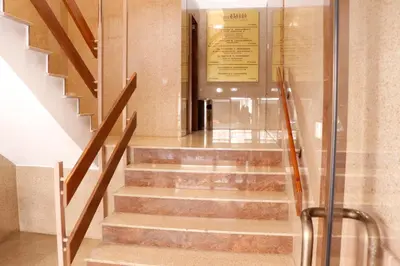 a staircase in a building with a glass door at Spacious Apartment, NEAR PINIKOUDES BEACH in Larnaka