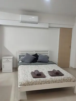 a bedroom with a bed with two towels on it at Alkinoos Studio in Nicosia